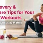 Woman foam rolling her glutes for post-workout recovery, illustrating self-care tips for booty workouts with healthy food and hydration nearby.