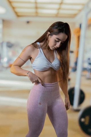 Woman adjusting leggings in gym